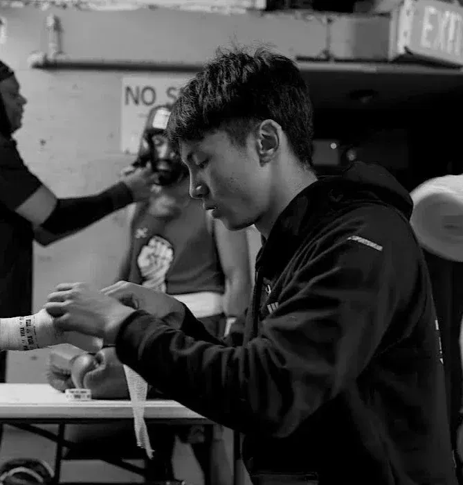 A Corner boxer wrapping his hands before training