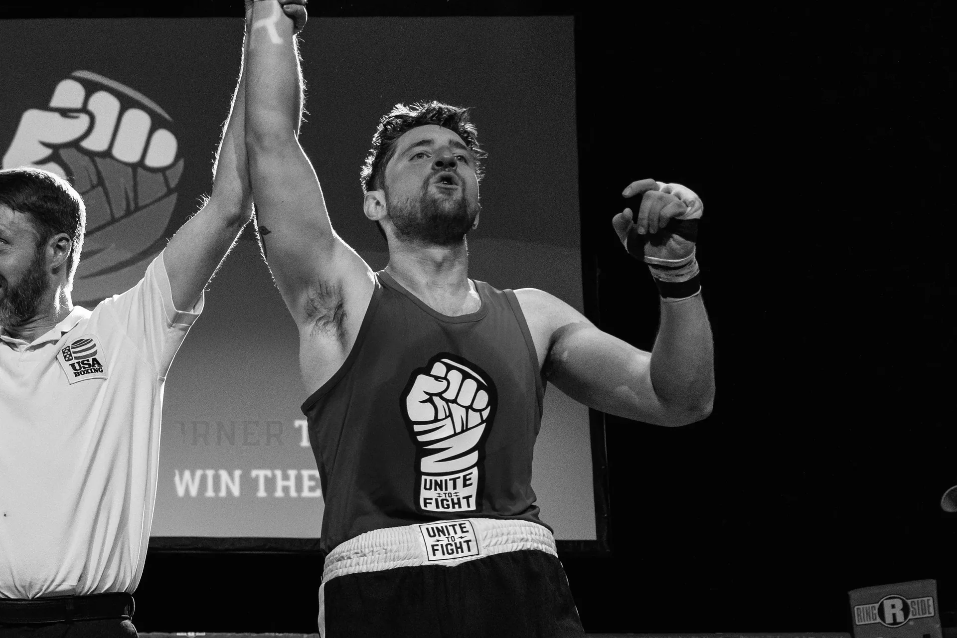 A fighter's hand raised in victory at The Corner Boxing Club